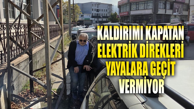 Kaldırımı kapatan elektrik direkleri yayalara geçit vermiyor